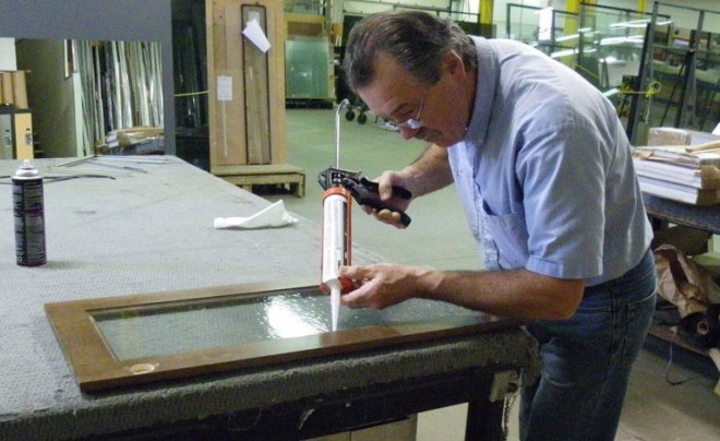 Barrie Glass & Mirror technician cutting glass to size in the shop